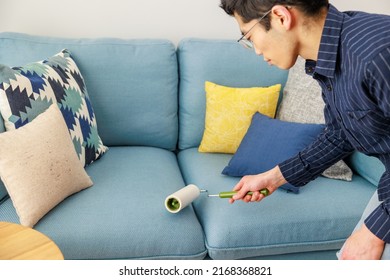 A Man Cleaning With An Adhesive Carpet Cleaner