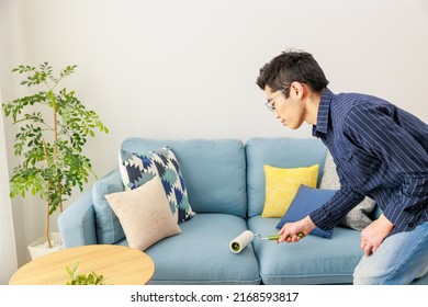 A Man Cleaning With An Adhesive Carpet Cleaner