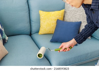 A Man Cleaning With An Adhesive Carpet Cleaner