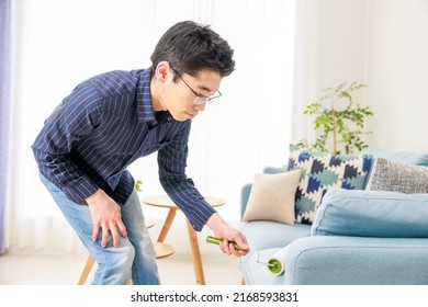 A Man Cleaning With An Adhesive Carpet Cleaner