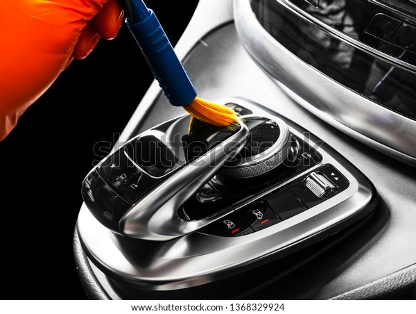 A man cleaning car with brush. Car detailing or\
valeting concept. Car detailing. Cleaning with sponge. Car wash\
concept solution to clean