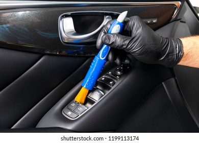A man cleaning car with cloth and brush. Car detailing. Selective focus. Car detailing. Cleaning with brush. Carwash and cleaning solution concept