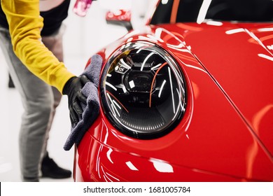 A man cleaning car with cloth, car detailing (or valeting) concept. Selective focus.  - Shutterstock ID 1681005784