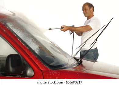 Man Cleaning Car With High Pressure Water Blaster