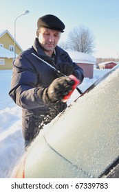  Man cleaning a car from ice