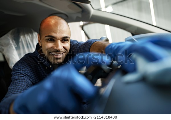 A man cleaning car interior, car detailing in\
Carwash service