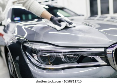 A man cleaning car with microfiber cloth, car detailing (or valeting) concept. Selective focus.  - Powered by Shutterstock