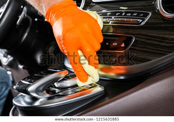A man\
cleaning car with microfiber cloth. Car detailing. Selective focus.\
Car detailing. Cleaning with sponge. Worker cleaning. Microfiber\
and cleaning solution to clean.\
