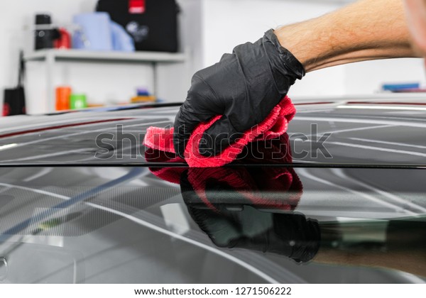 A\
man cleaning car with microfiber cloth. Car detailing concept. Car\
detailing. Cleaning with sponge. Car Worker cleaning with\
Microfiber. Solution to clean. Vehicle washing\
station