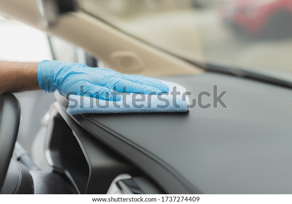 Man cleaning car with
microfiber cloth