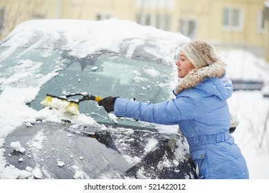 Man Cleaning Car From Snow