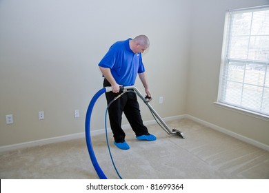 Man Cleaning Carpet With Commercial Cleaning Equipment