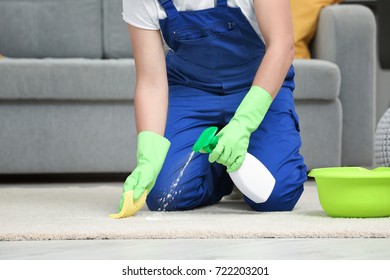 Man Cleaning Carpet In Living Room