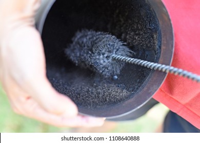 Man Cleaning Chimney Pipe Outside. Cleaning A Wood Burning Stove. Chimney Sweep Cleaning