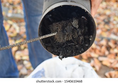 Man Cleaning Chimney Pipe Outside. Cleaning A Wood Burning Stove. Chimney Sweep Cleaning