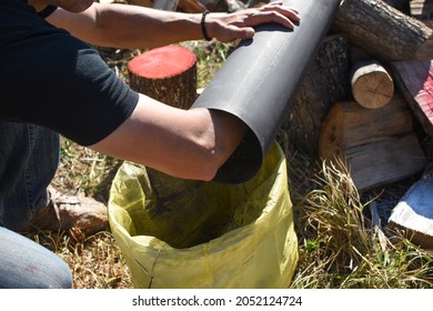 Man Cleaning Chimney Pipe Outside. Cleaning A Wood Burning Stove. Chimney Sweep Cleaning