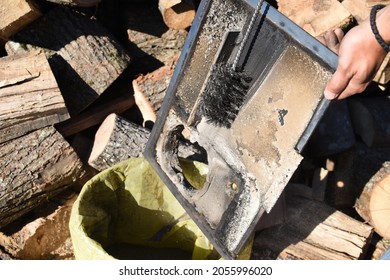 Man Cleaning Chimney Pipe Outside. Cleaning A Wood Burning Stove. Chimney Sweep Cleaning