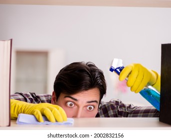 Man Cleaning Dust From Bookshelf