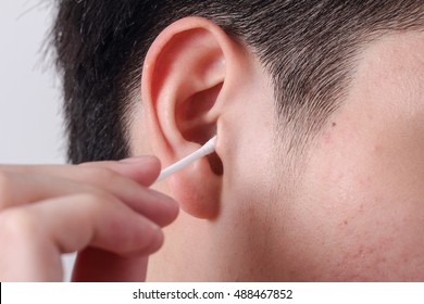 Man Cleaning Ear With Cotton Bud