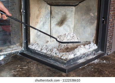 Man Cleaning Fireplace From Ashes