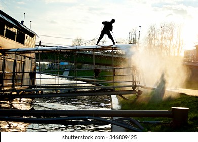 Man cleaning floating restaurant