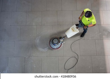 The man cleaning floor with machine.