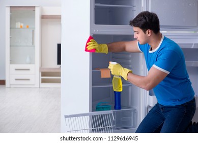 Man Cleaning Fridge In Hygiene Concept