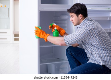 Man Cleaning Fridge In Hygiene Concept