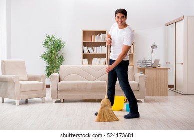 Man Cleaning Home With Broom