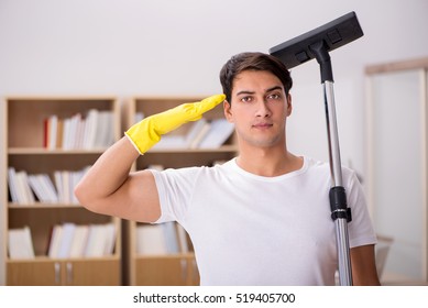 Man Cleaning Home With Vacuum Cleaner