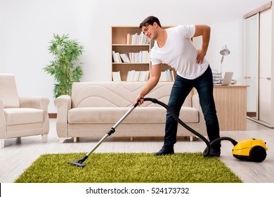 Man Cleaning Home With Vacuum Cleaner