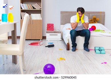 Man Cleaning The House After Christmas Party