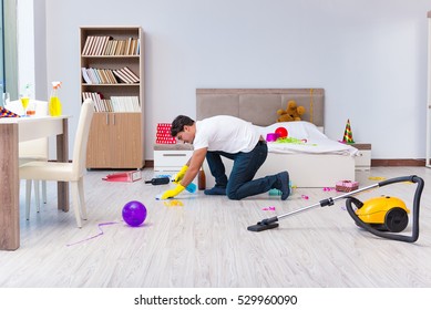 Man Cleaning The House After Christmas Party