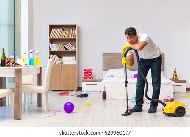 Man Cleaning The House After Christmas Party