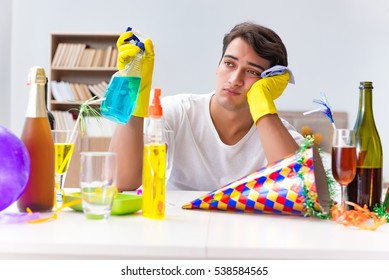 Man Cleaning The House After Christmas Party