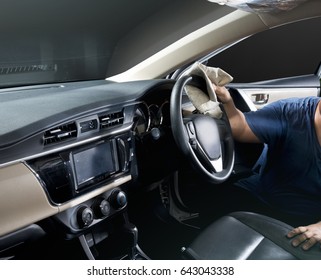 a man cleaning inside of his car. - Shutterstock ID 643043338