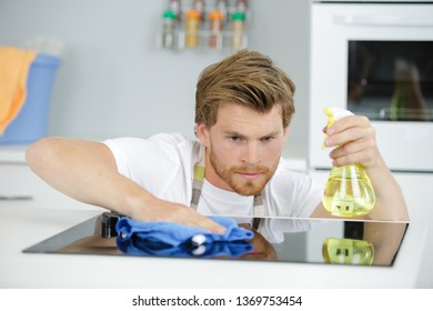 Man Cleaning Kitchen