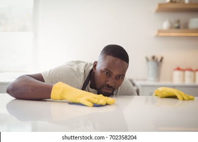 Man Cleaning The Kitchen Worktop At Home