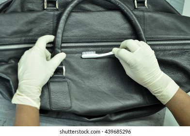 A Man Cleaning A Leather Bag By Brush To Remove Stains And Soils At Leather Laundry.