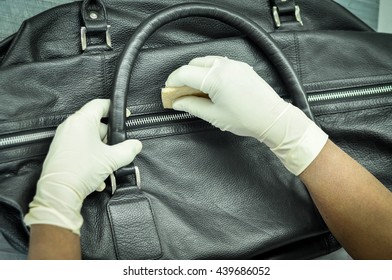 A Man Cleaning A Leather Bag To Remove Stains And Soils At Leather Laundry. 