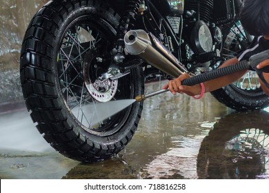 A man cleaning motorcycle - Powered by Shutterstock