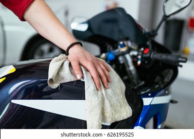 A man cleaning motorcycle - motorcycle detailing (or valeting) concept. Selective focus.  - Powered by Shutterstock