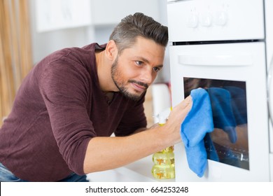 Man Cleaning Oven