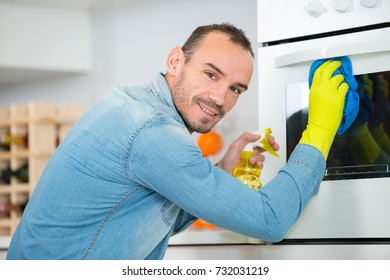 Man Cleaning Oven At Home