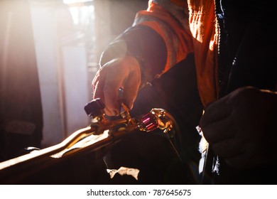 Man cleaning oxy acetylene torch propane tools for cutting metal in his workshop - Powered by Shutterstock