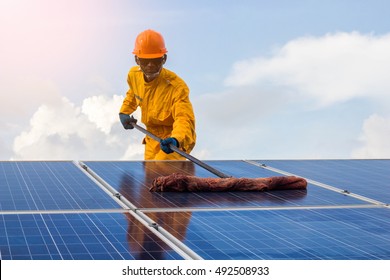 A man cleaning of solar cell.the concept of work on solar energy module.