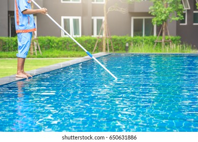 Man cleaning the swimming pool