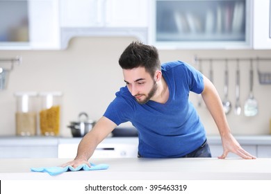 Man Cleaning Table In The Kitchen