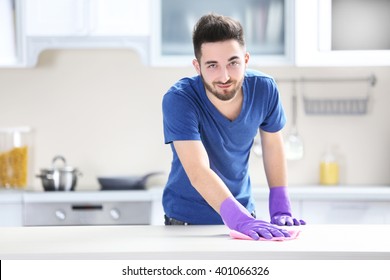 Man Cleaning Table In The Kitchen