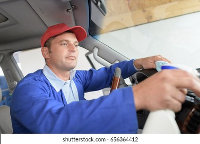 Man Cleaning Vehicle Cab